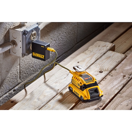 charger plugged into a DEWALT wall plug