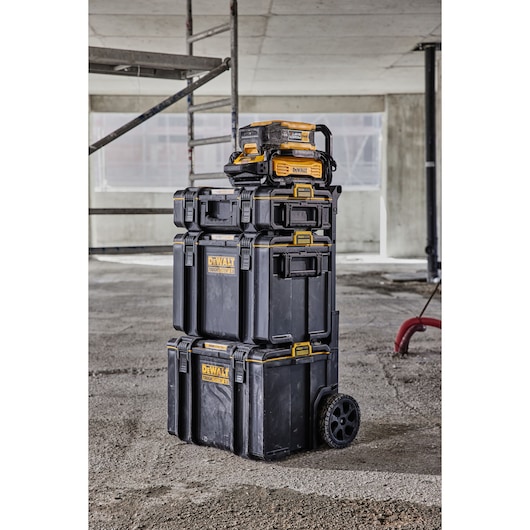 Powershift 554WH battery stacked on top of ToughSystem storage on a construction site