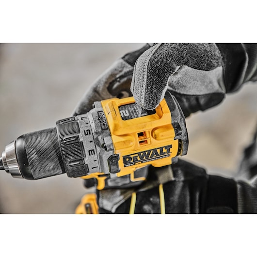 A gloved hand adjusting the speed setting on a DCD800E2T 18V XR Brushless Drill Driver