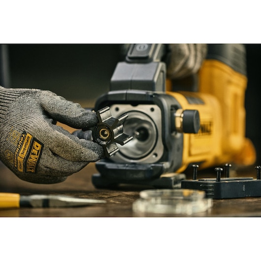 DEWALT 18V XR Transfer Pump on table top with worker changing the impeller