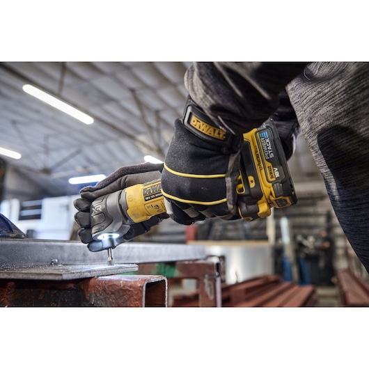 DEWALT 18V XR Compact Inline Die Grinder deburring the inside of a hole on a metal plate