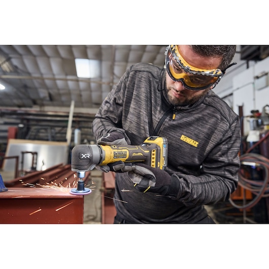 DEWALT 18V XR Compact Inline Die Grinder smoothing a metal surface