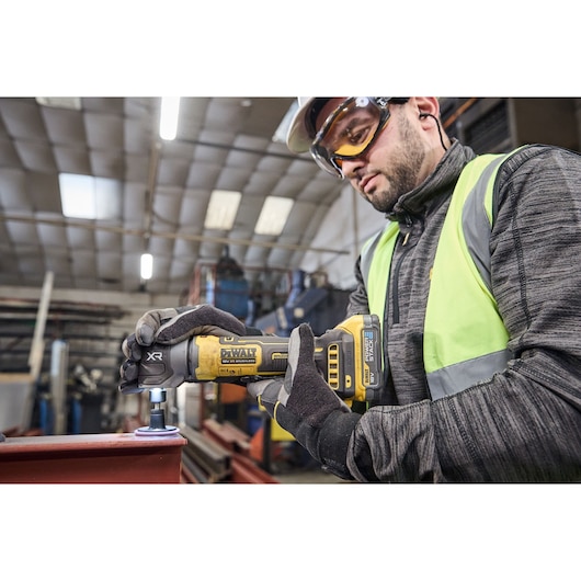 DEWALT 18V XR Compact Inline Die Grinder smoothing a metal surface