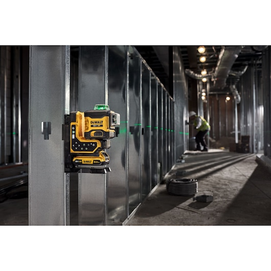 The 18V 3X 360 Remote Control Laser in use attached to metal frame with its magnetic bracket