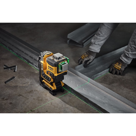Someone laying flooring using the 20V MAX* XR® Remote Control 360º Line Laser