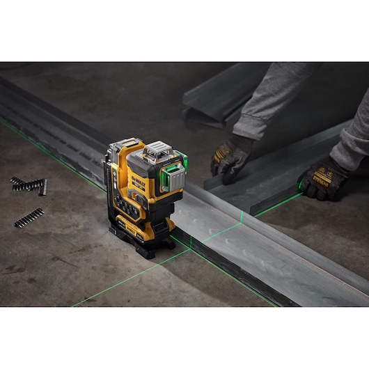 The 18V 3X 360 Remote Control Laser in use sitting on work floor with green beam diodes