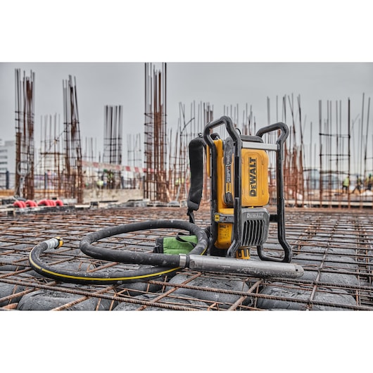 Powershift Backpack Concrete Vibrator standing on a bed of rebar