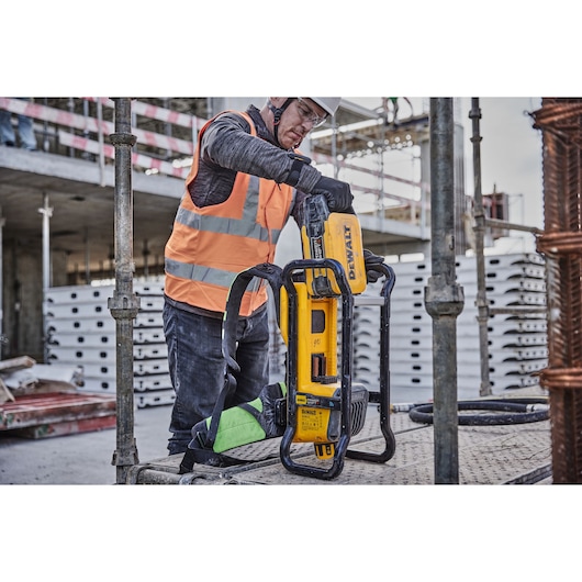 Powershift battery DCBPS0554 being inserted into Powershift Backpack Concrete Vibrator