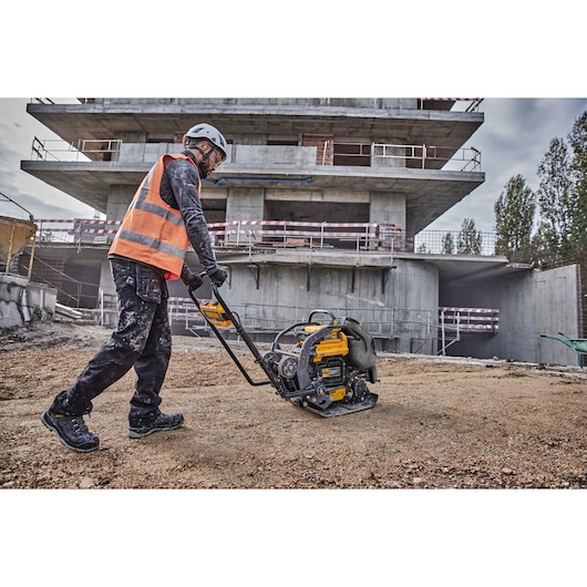 Worker uses Powershift Plate Compactor to compress the ground on a construction site