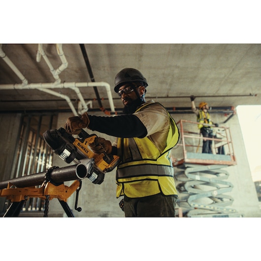 DEWALT Equity photography: Construction worker on site with DEWALT mitre saw