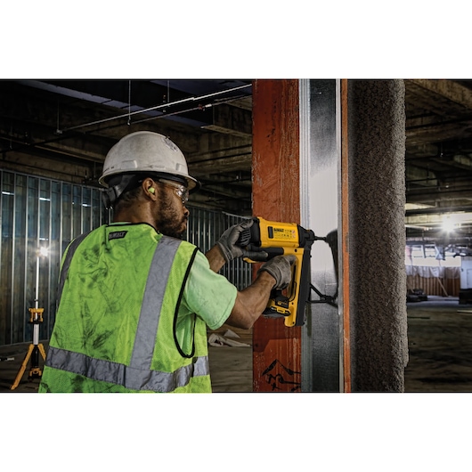 Trak-It C6 Gas Concrete Nailer being used by a person to install drywall track into steel substrate.