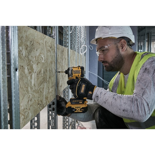 Impact driver screwdriving OSB into metal framework using a 57mm Flextorq bit