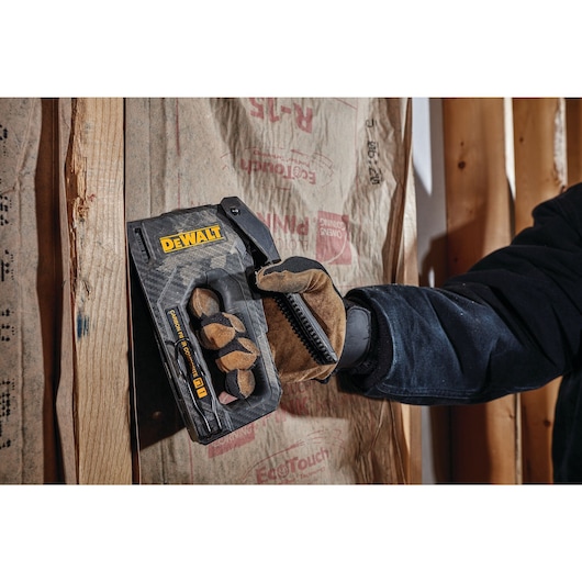 Close up of  Carbon Fiber Composite Staple Gun being used to staple material.